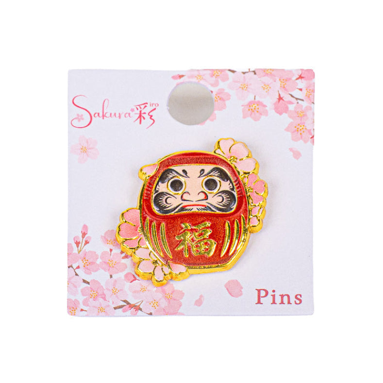 Insignia japonesa de metal con motivos de Daruma y Sakura
